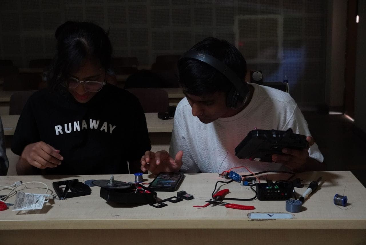 Students collaborating on electronics hardware